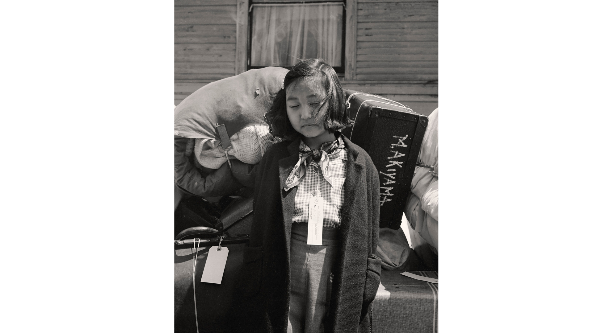 Dorothea Lange
La giovane evacuata Kimiko Kitagaki sorveglia i bagagli della famiglia prima di partire in bus, tra mezz'ora, per il centro di raccolta di Tanforan. Suo padre ha lavorato nel settore del lavaggio e della tintoria fino al giorno dell'evacuazione
Oakland, California. 1942
The New York Public Library | Library of Congress Prints and Photographs Division Washington