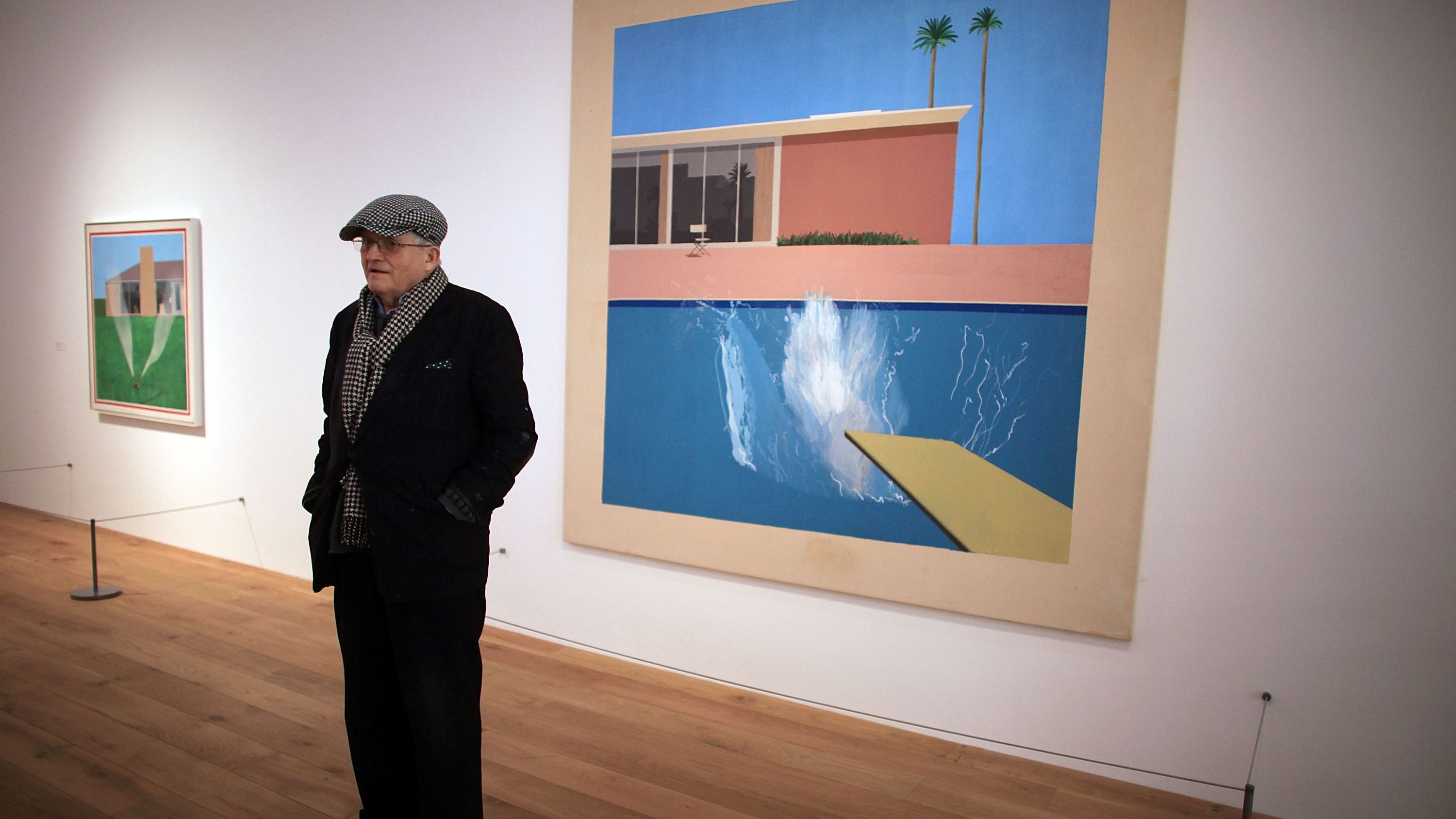 David Hockney davanti alla sua opera “A bigger splash 1967” esposta presso il Nottingham Contemporary Art 
Credit: Getty Images