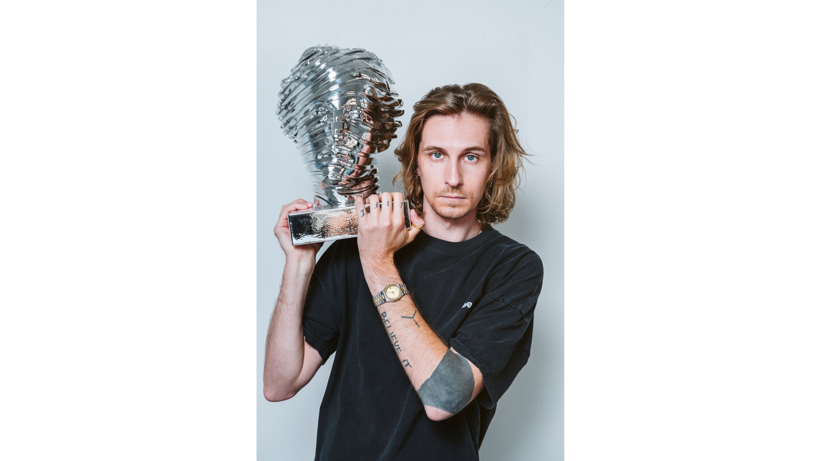 Andrea Crespi with the Head of Aphrodite, 2024, metallic finish on resin - Credits: Courtesy Press Office