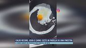 Caldo record, uova e carne cotte in padella su una finestra