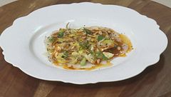 Carpaccio di scampi, insalatina di carciofi al limone e pinoli tostati